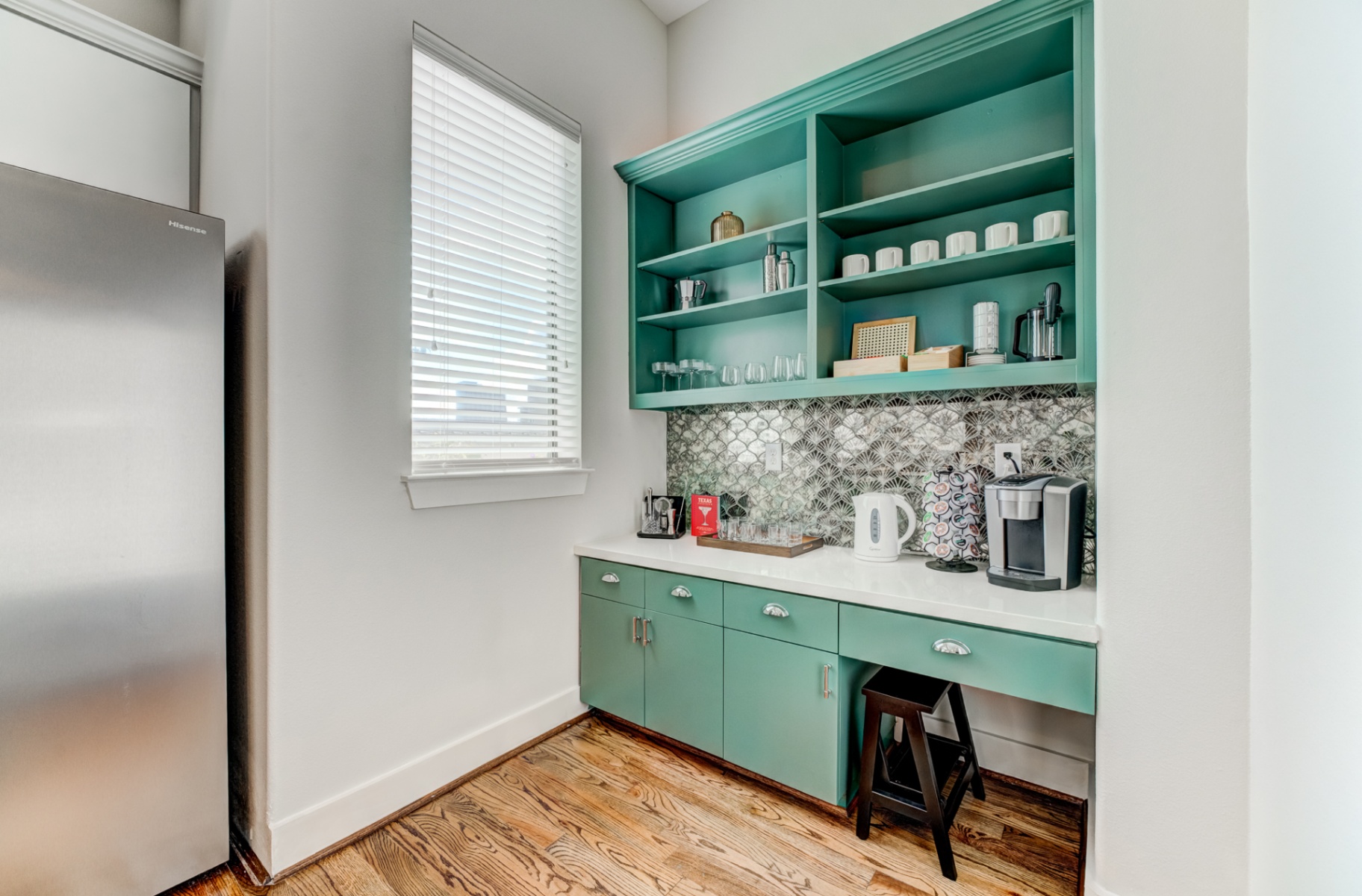 Coffee and cocktail station with teal open shelving